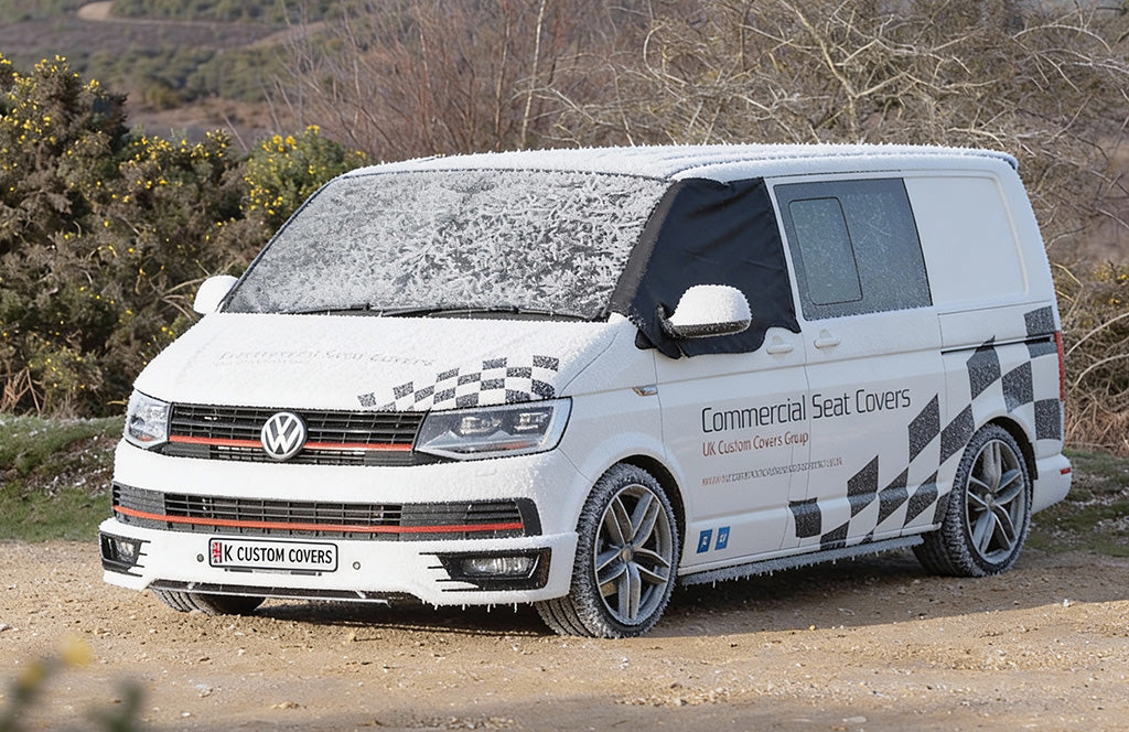 VW Transporter with a black screen wrap over the windscreen protecting from the snow 