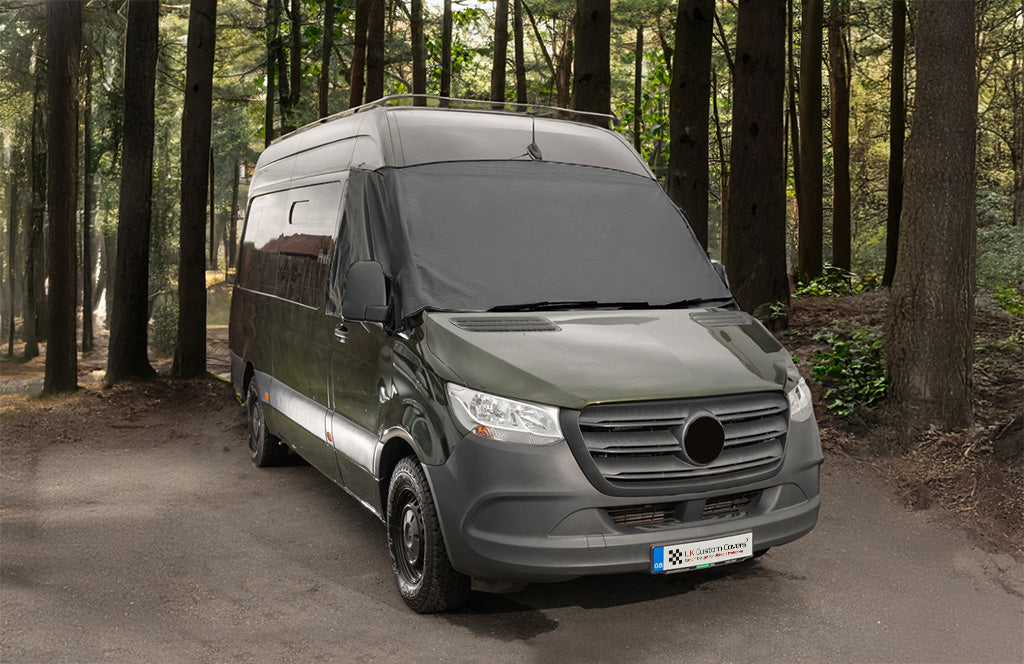 Campervan outside with a black screen wrap over the screen 