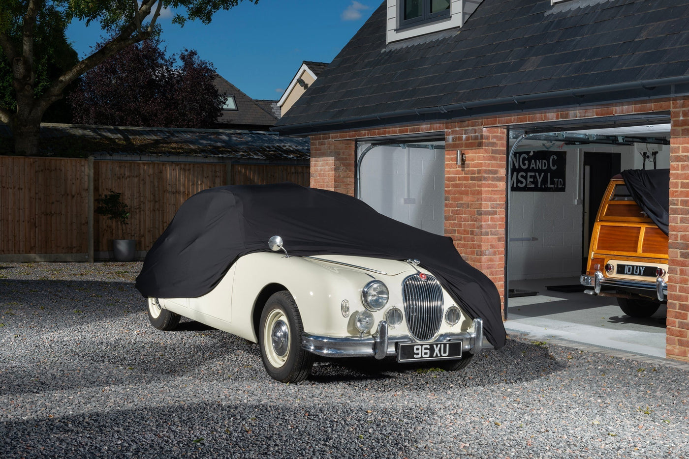 Jaguar With a black indoor car cover over the top showing the front of the car
