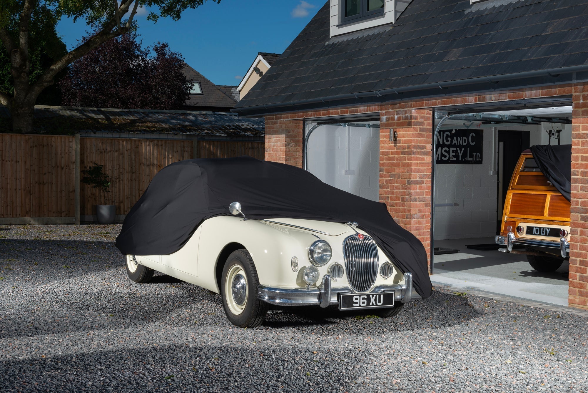 Jaguar With a black indoor car cover over the top showing the front of the car