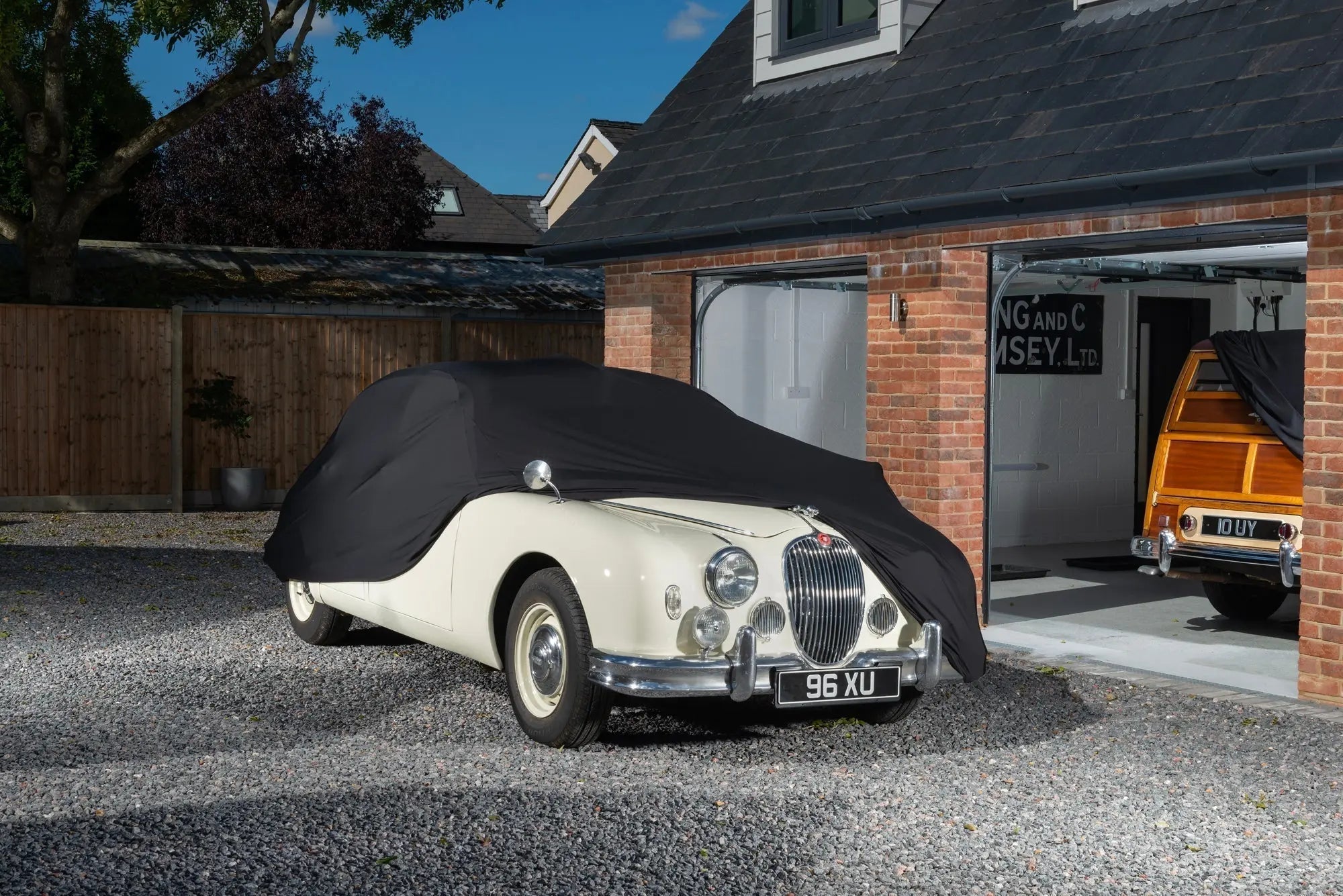 Jaguar With a black indoor car cover over the top showing the front of the car